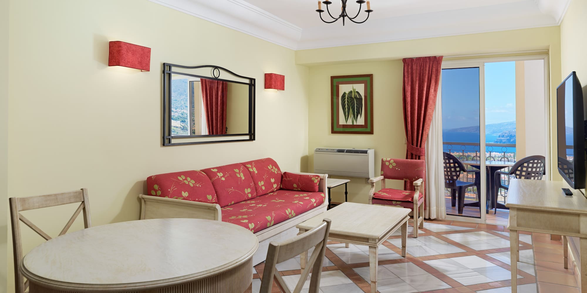 a room with a table and chairs and a mirror