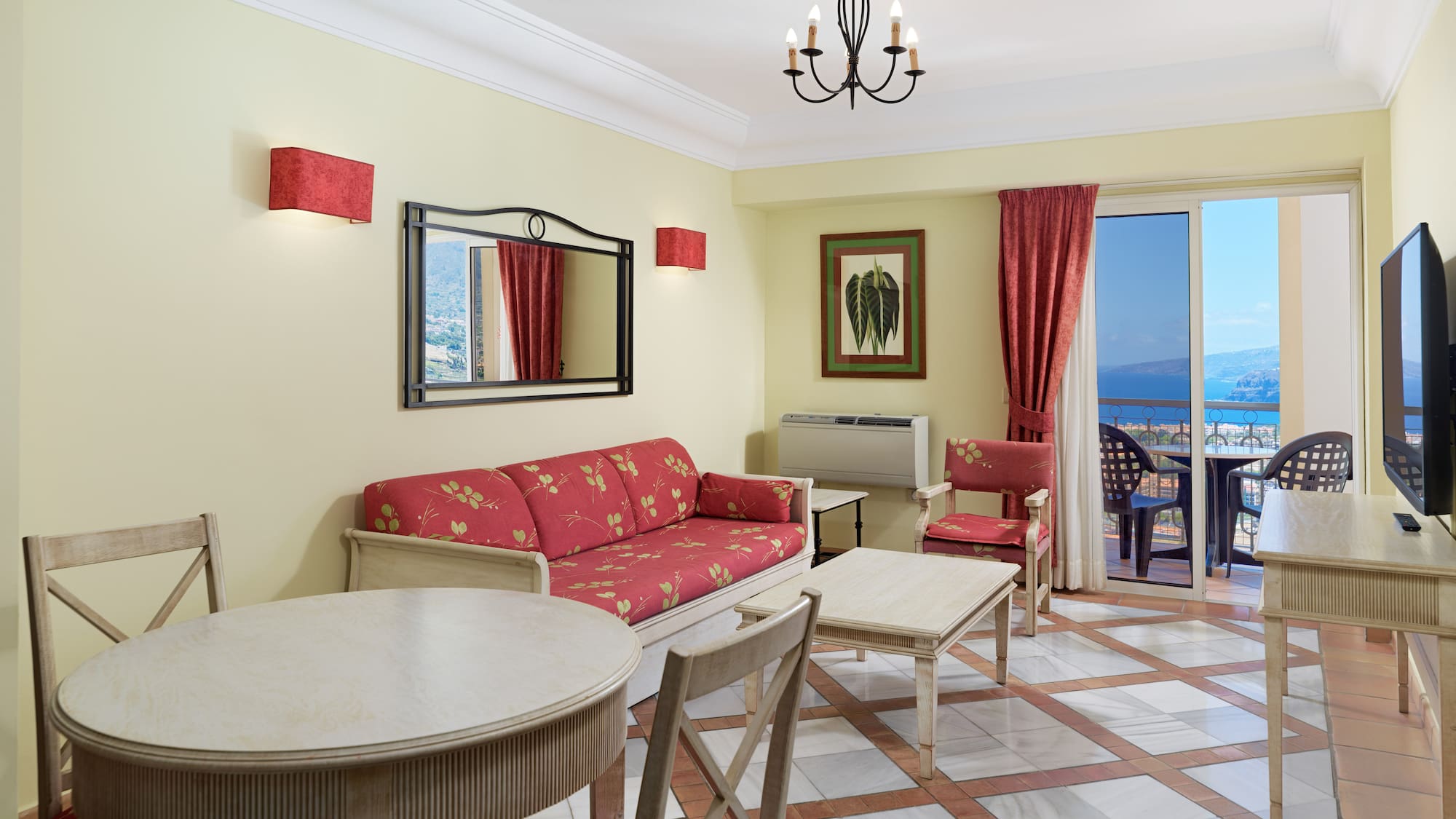 a room with a table and chairs and a mirror