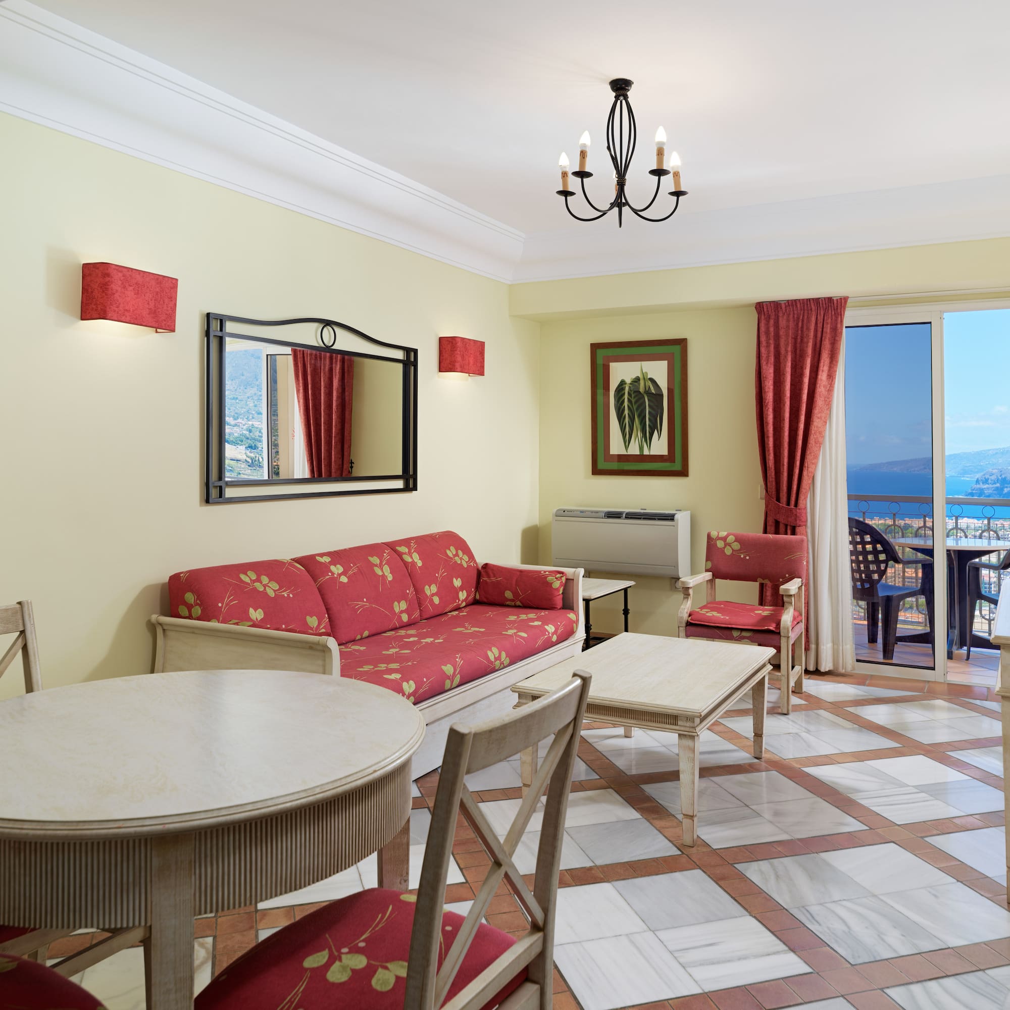 a room with a table and chairs and a mirror