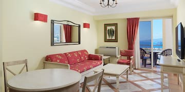 a room with a table and chairs and a mirror