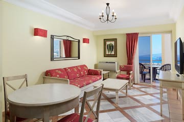 a room with a table and chairs and a mirror