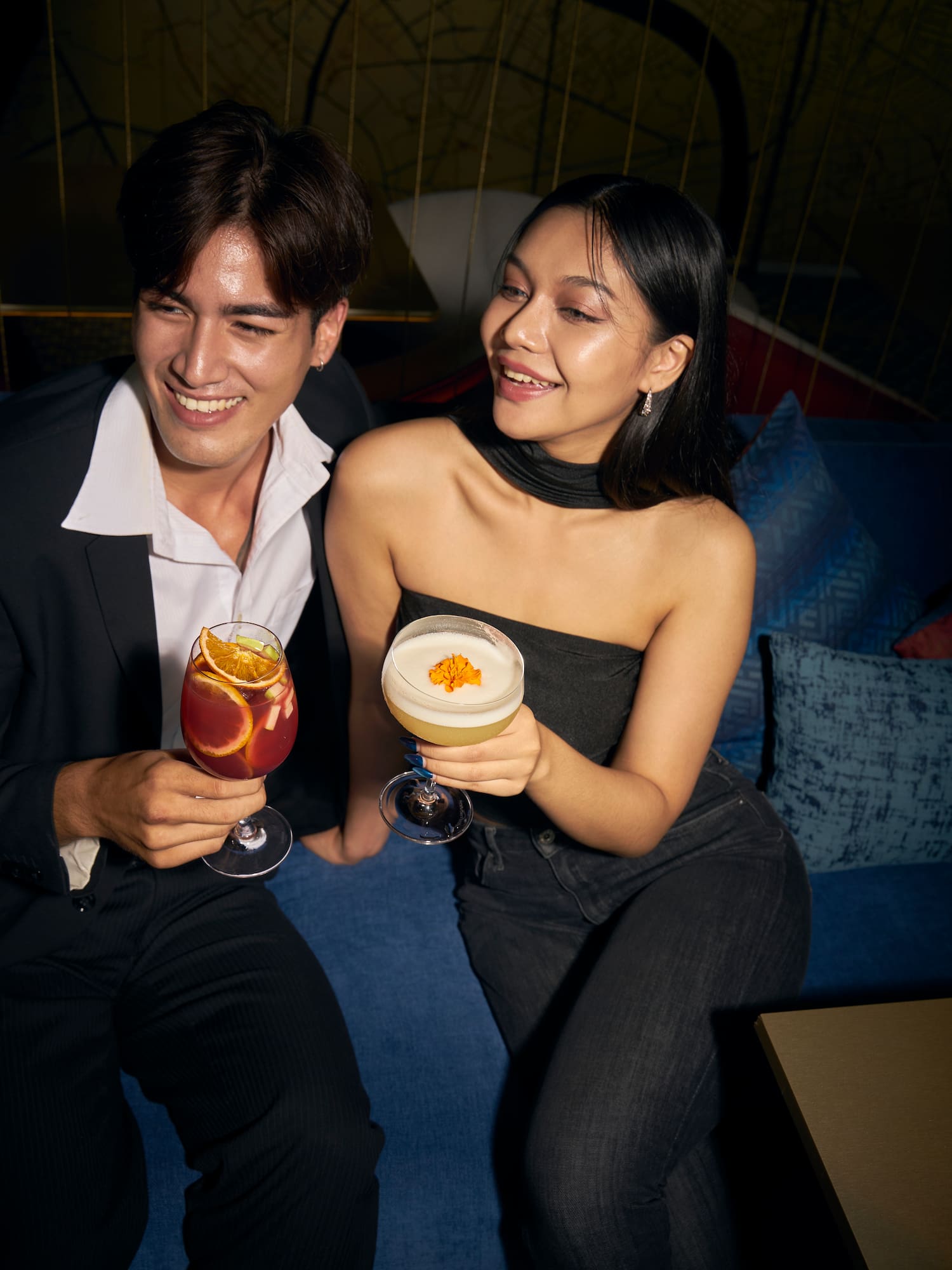 a man and woman holding drinks