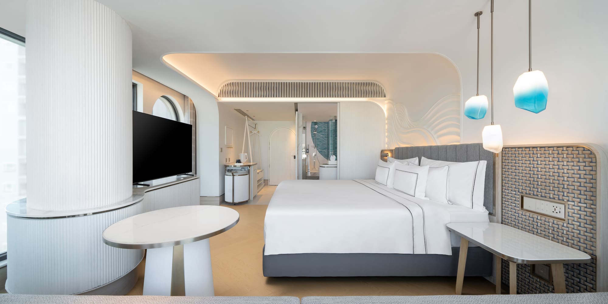 a room with a bed and a television