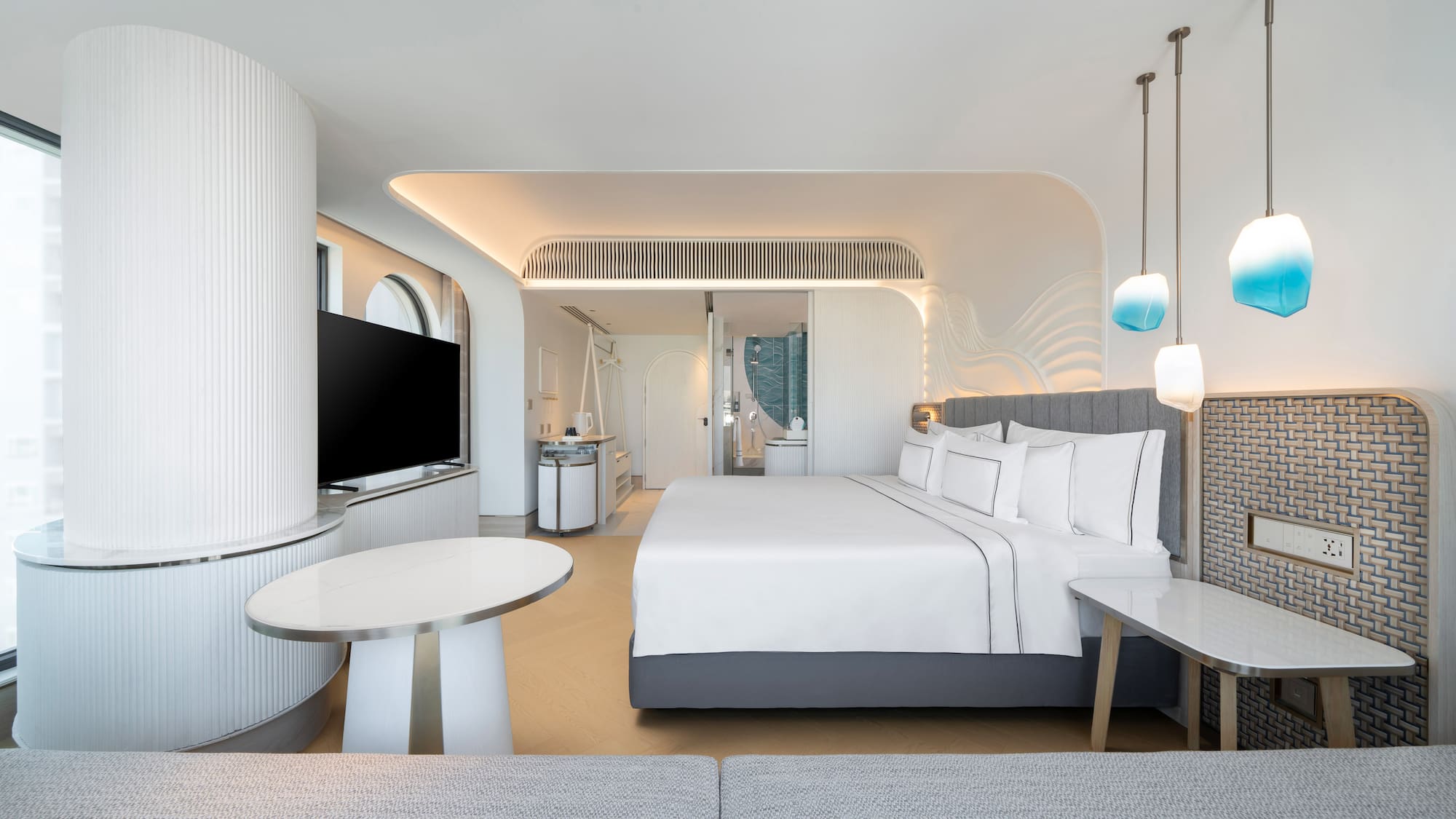 a room with a bed and a television