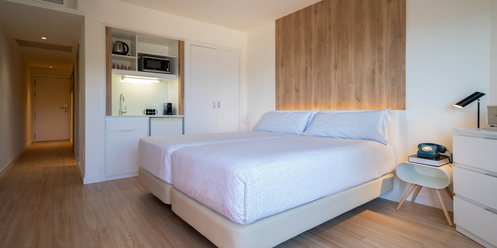 a bedroom with a bed and a microwave