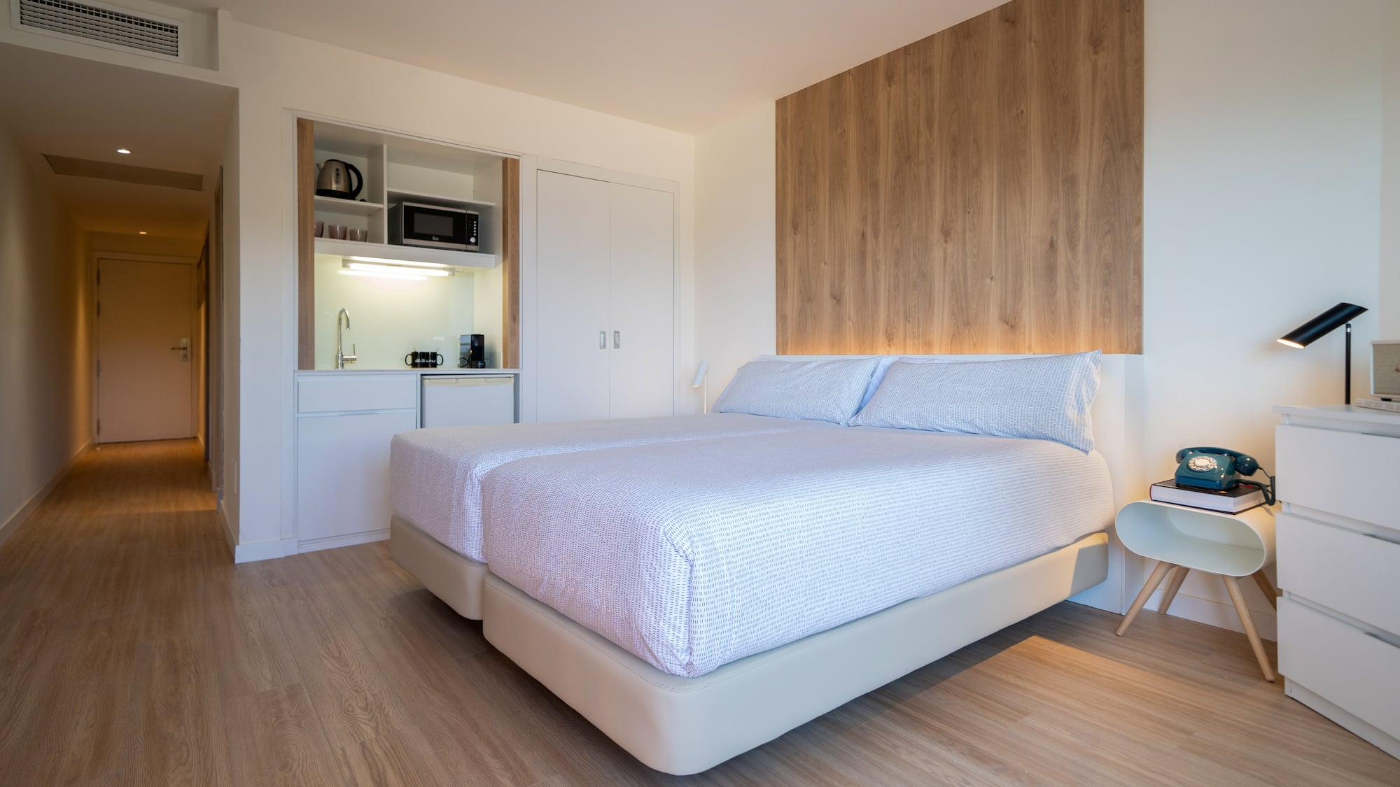 a bedroom with a bed and a microwave