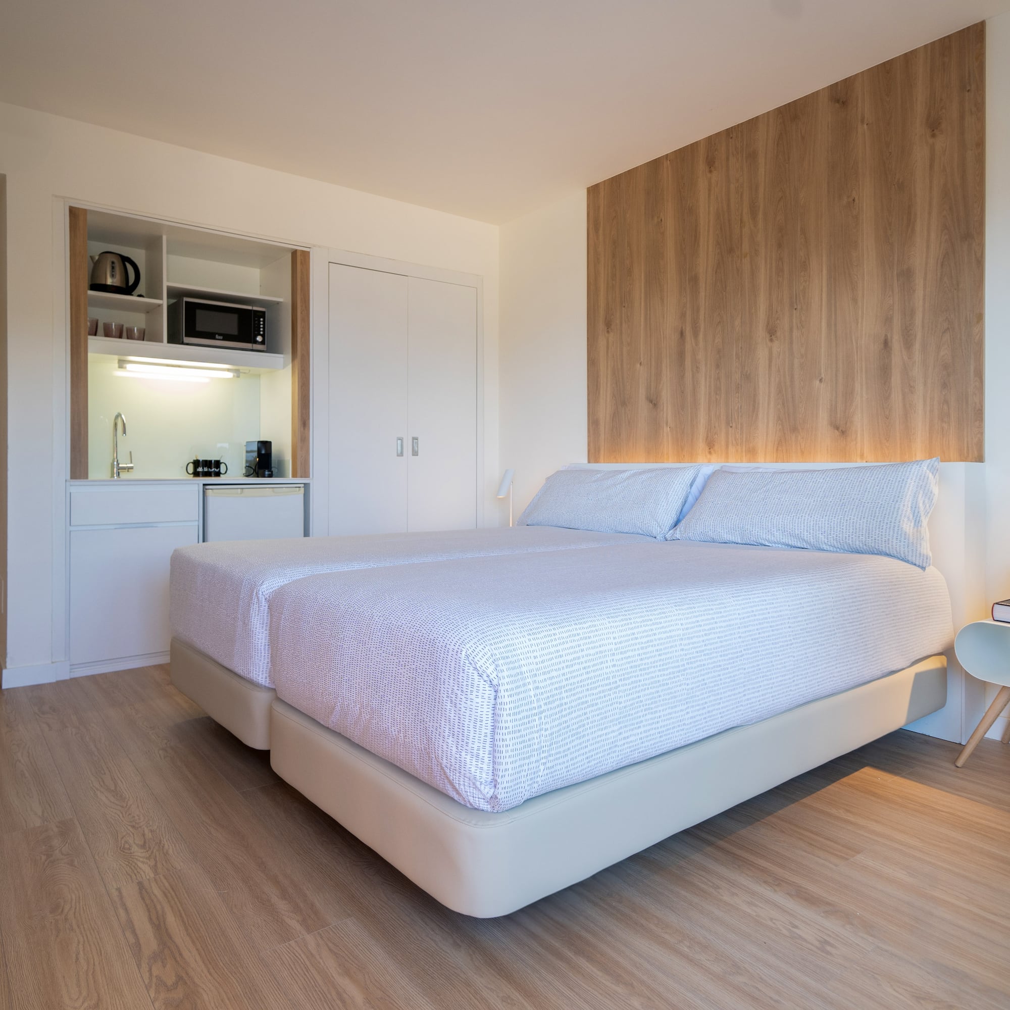 a bedroom with a bed and a microwave