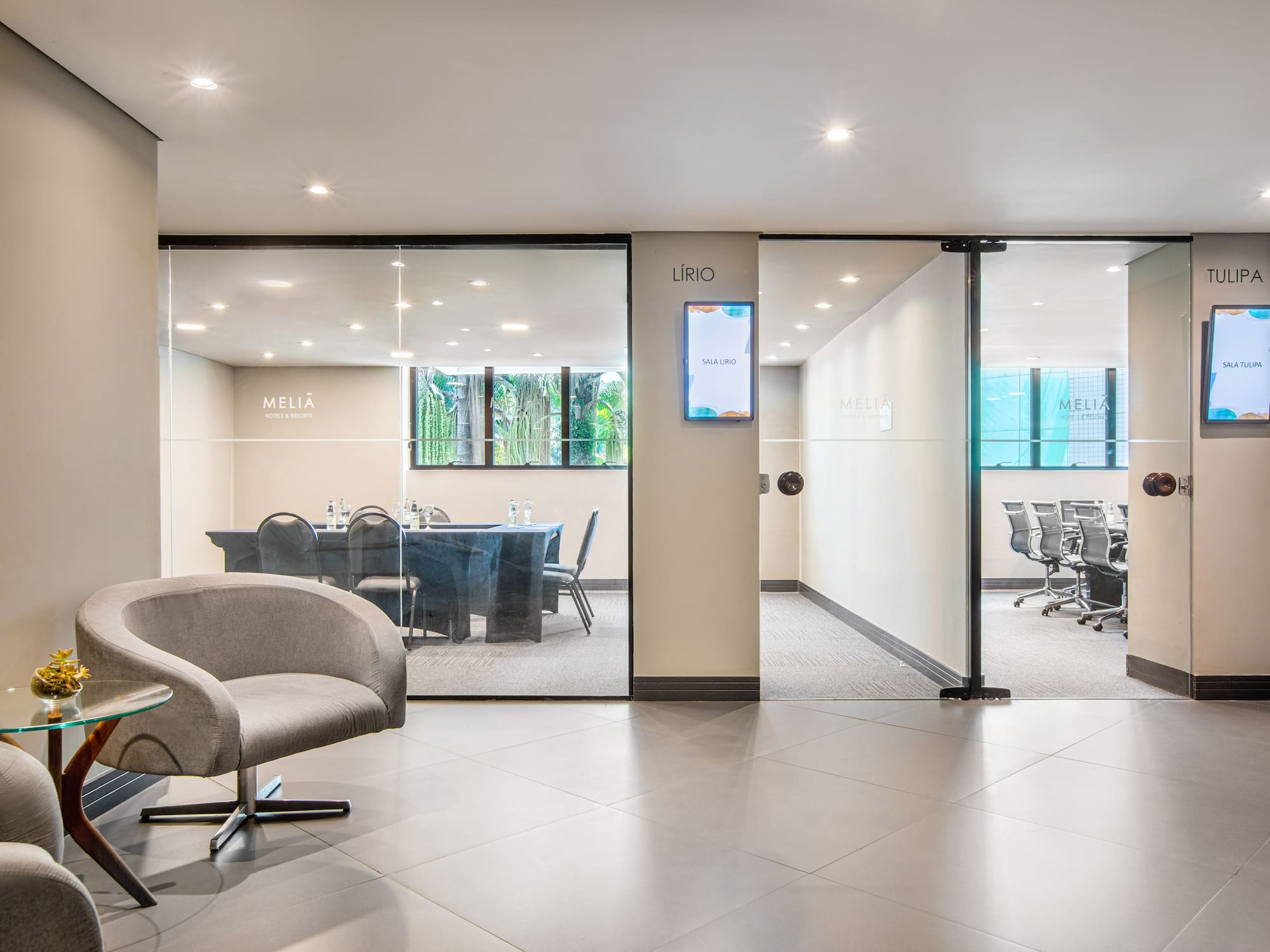 a glass wall with a chair and a table in front of it