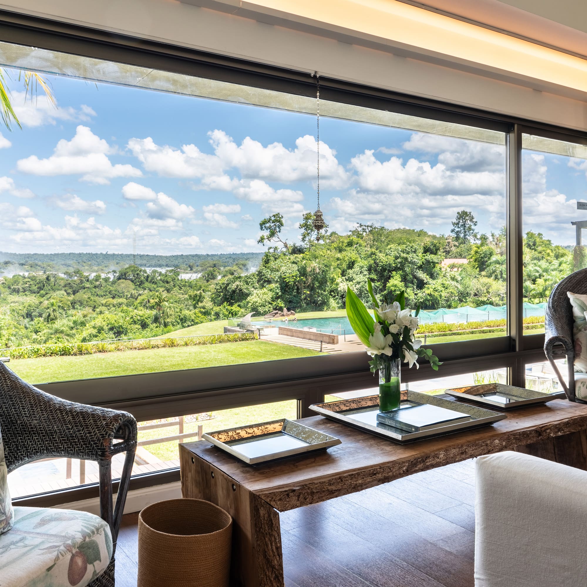 a room with a large window and a view of the landscape