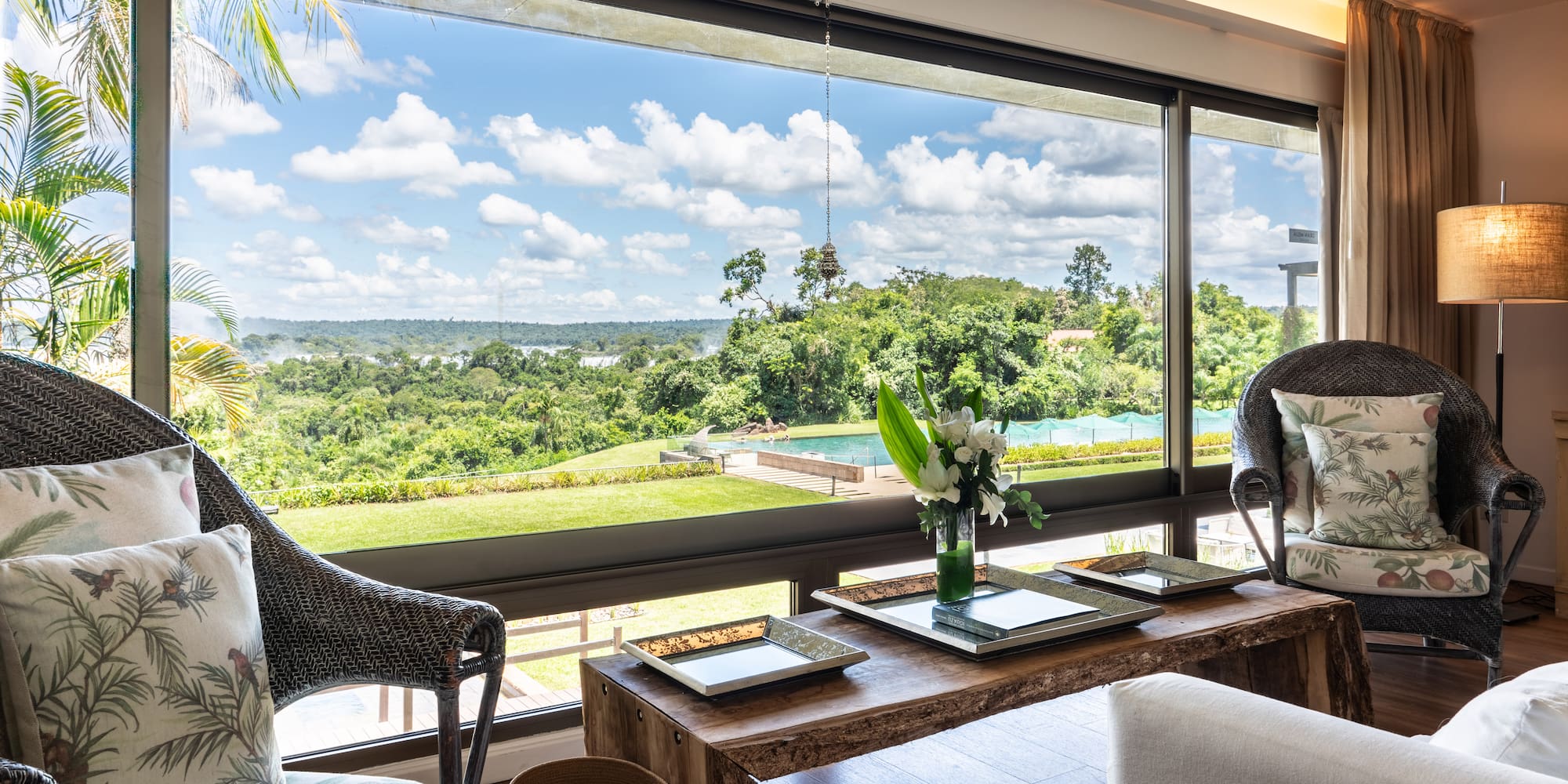 a room with a large window and a view of the landscape