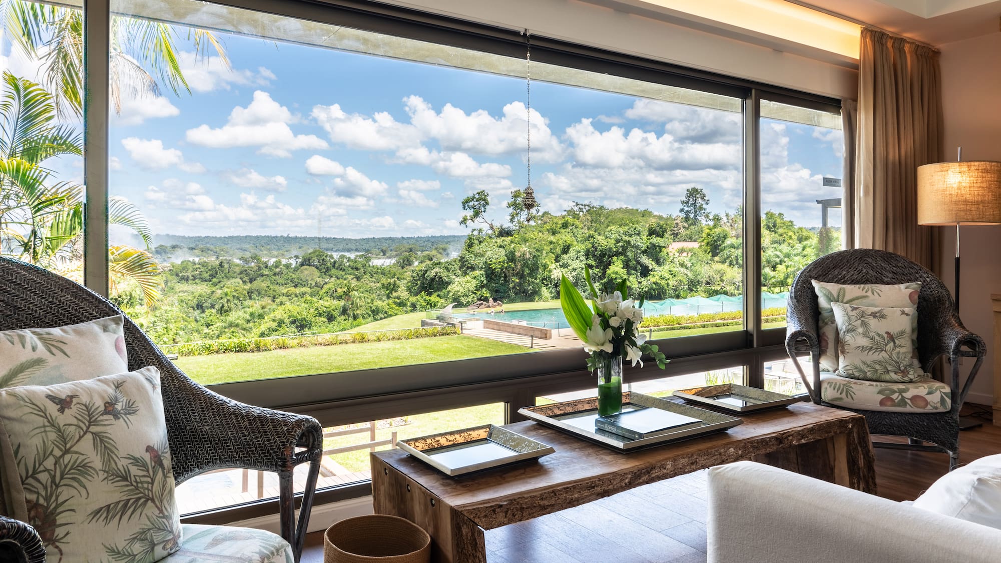 a room with a large window and a view of the landscape