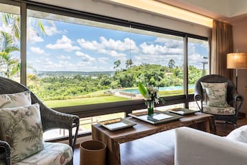a room with a large window and a view of the landscape