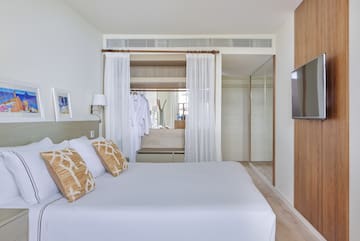 a bedroom with a bed and a mirror