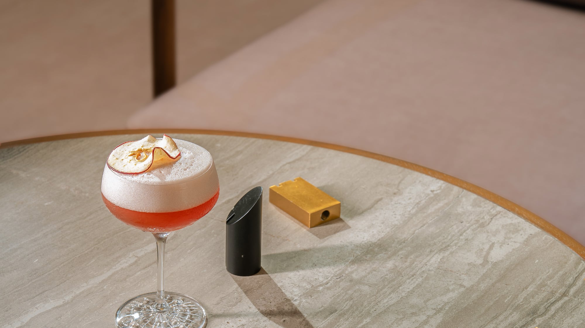 a glass of liquid on a table