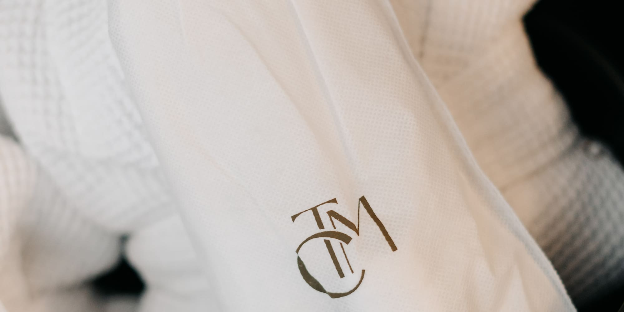 a white bathrobe with a logo on it