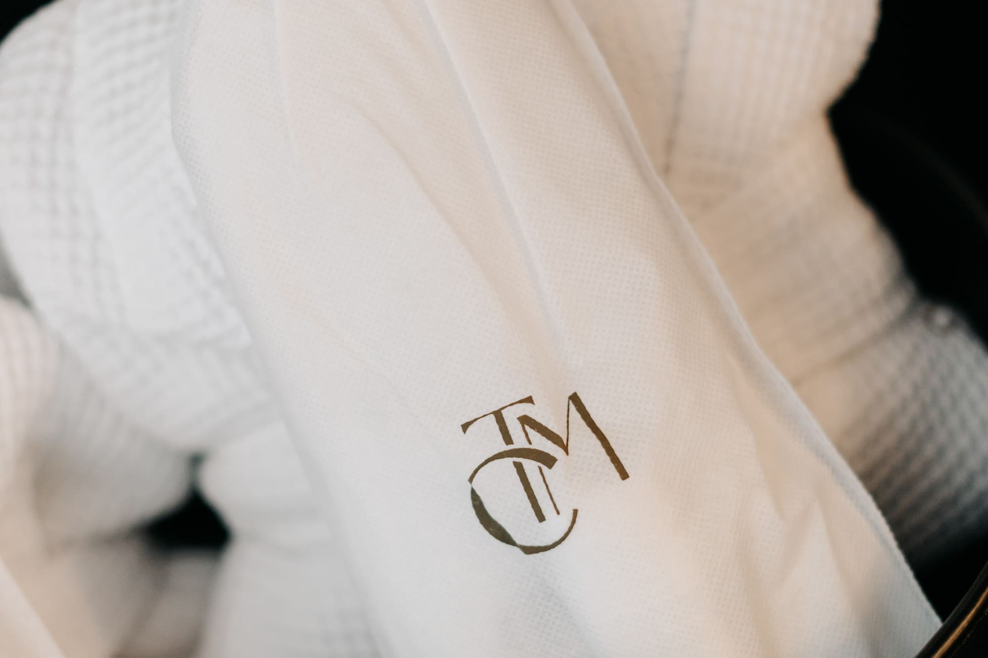a white bathrobe with a logo on it