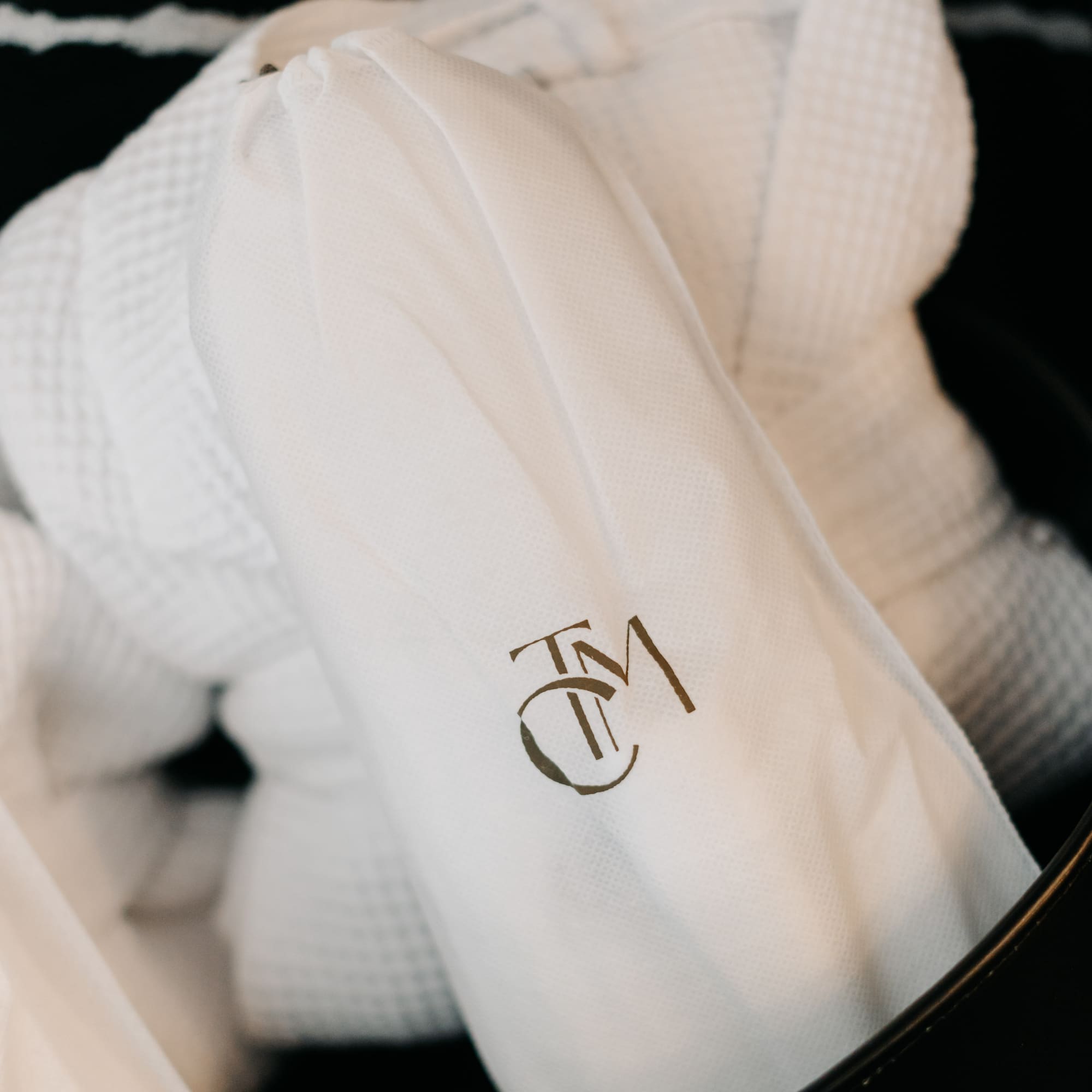 a white robe with a logo on it