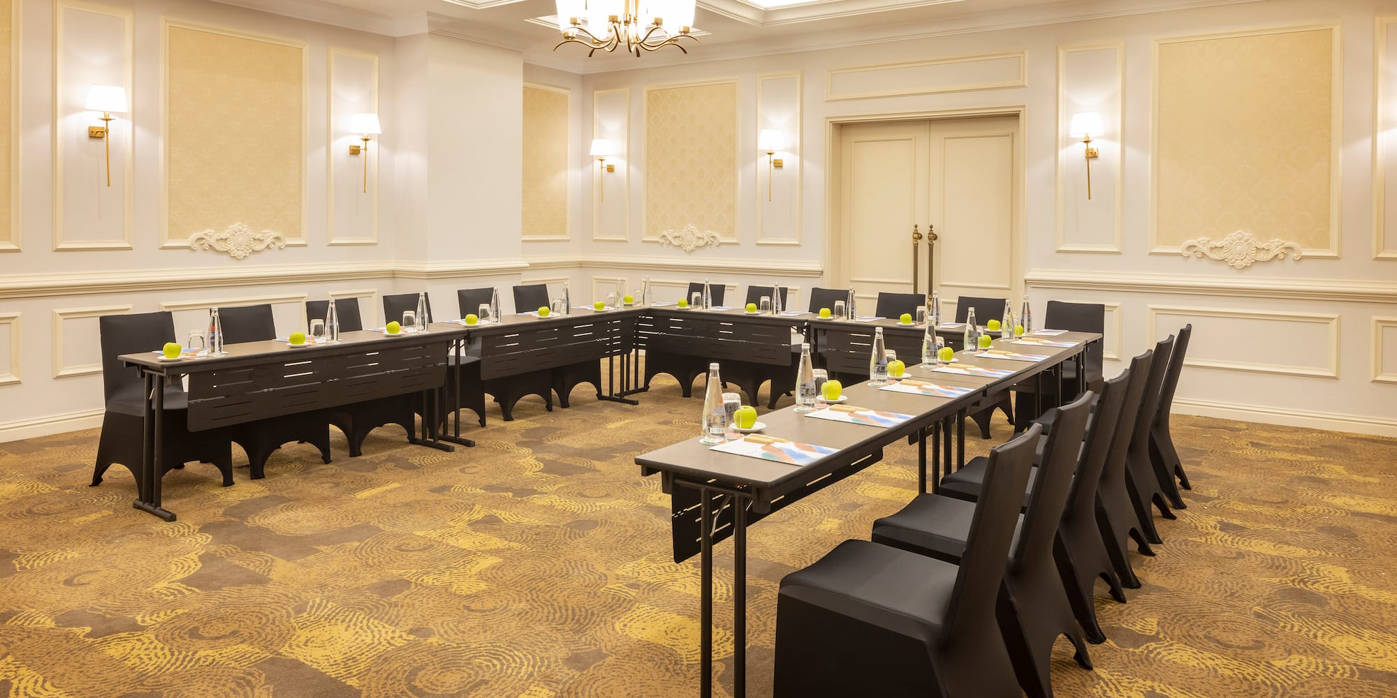 a room with long tables and chairs