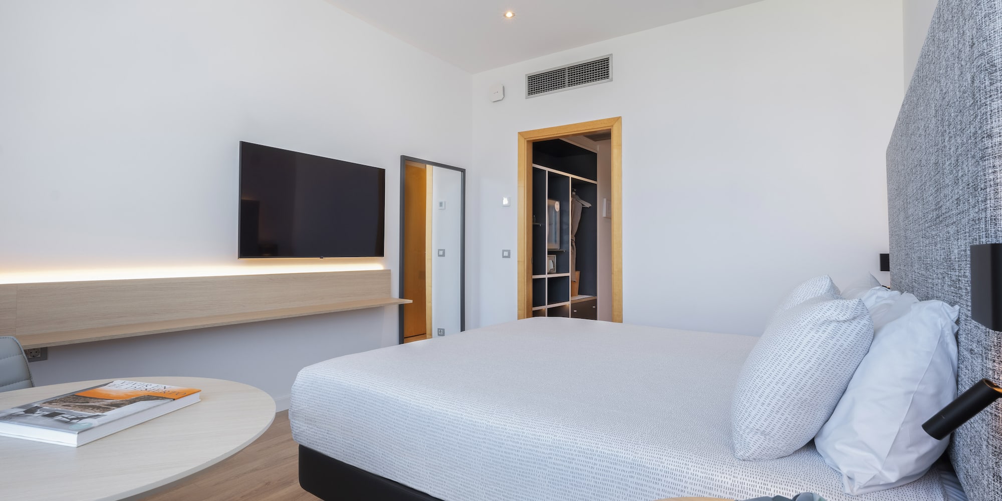 a bedroom with a bed and a television
