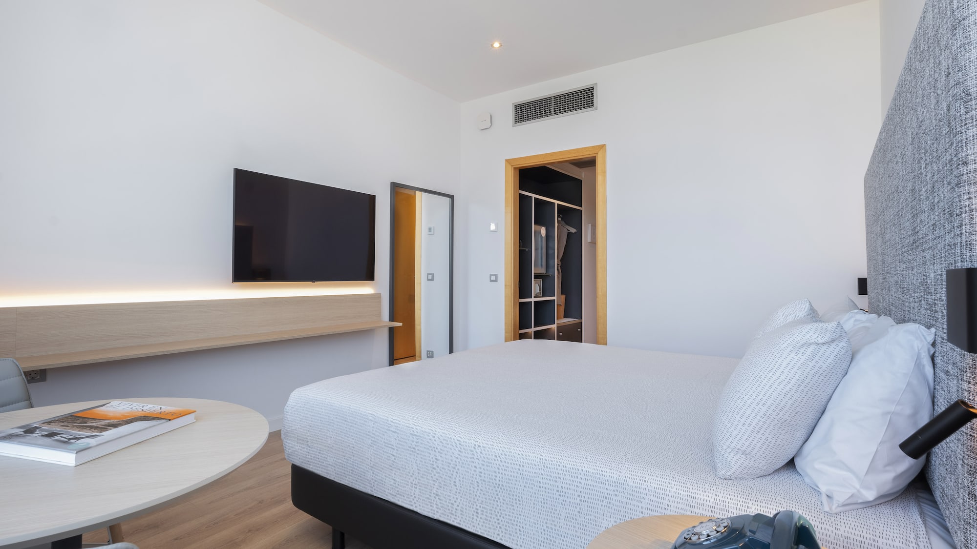 a bedroom with a bed and a television