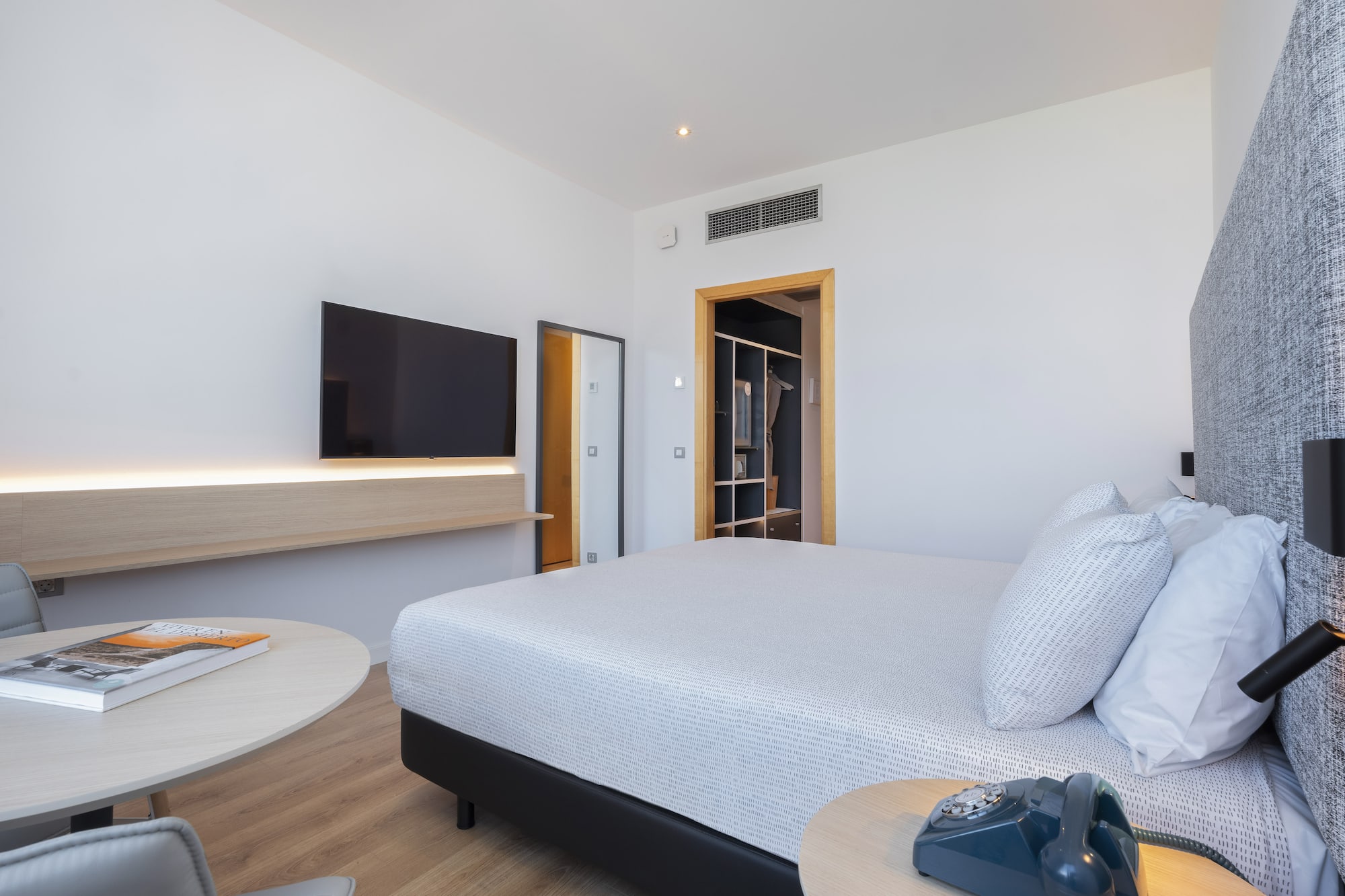 a bedroom with a bed and a television