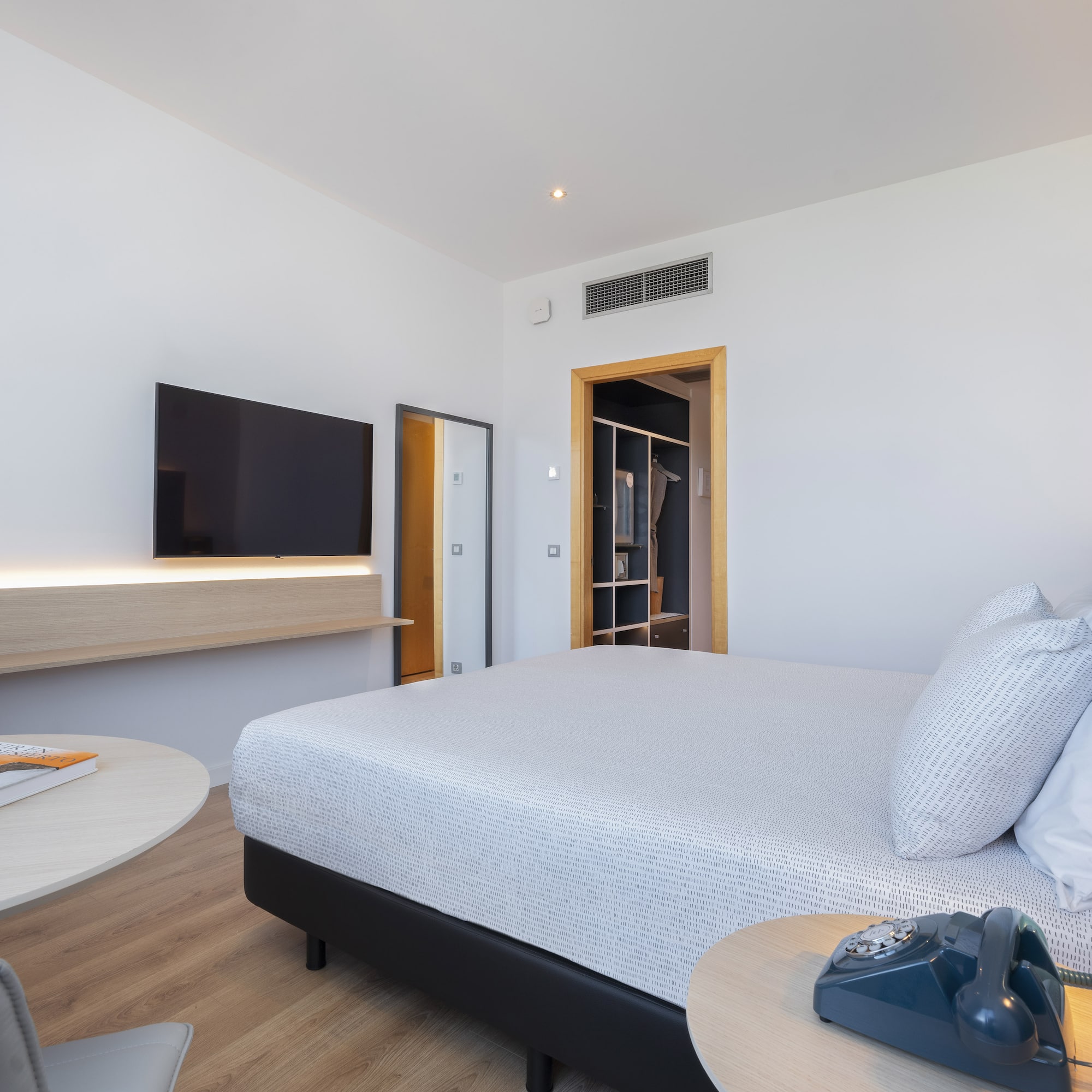 a bedroom with a bed and a television