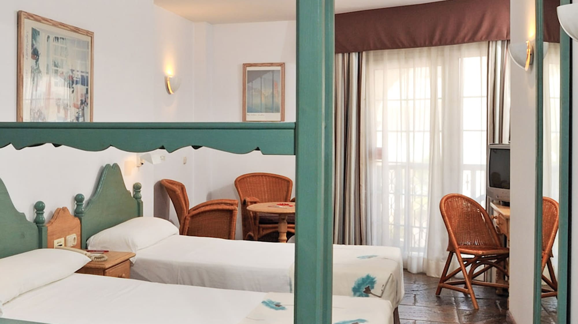 a room with two beds and a television