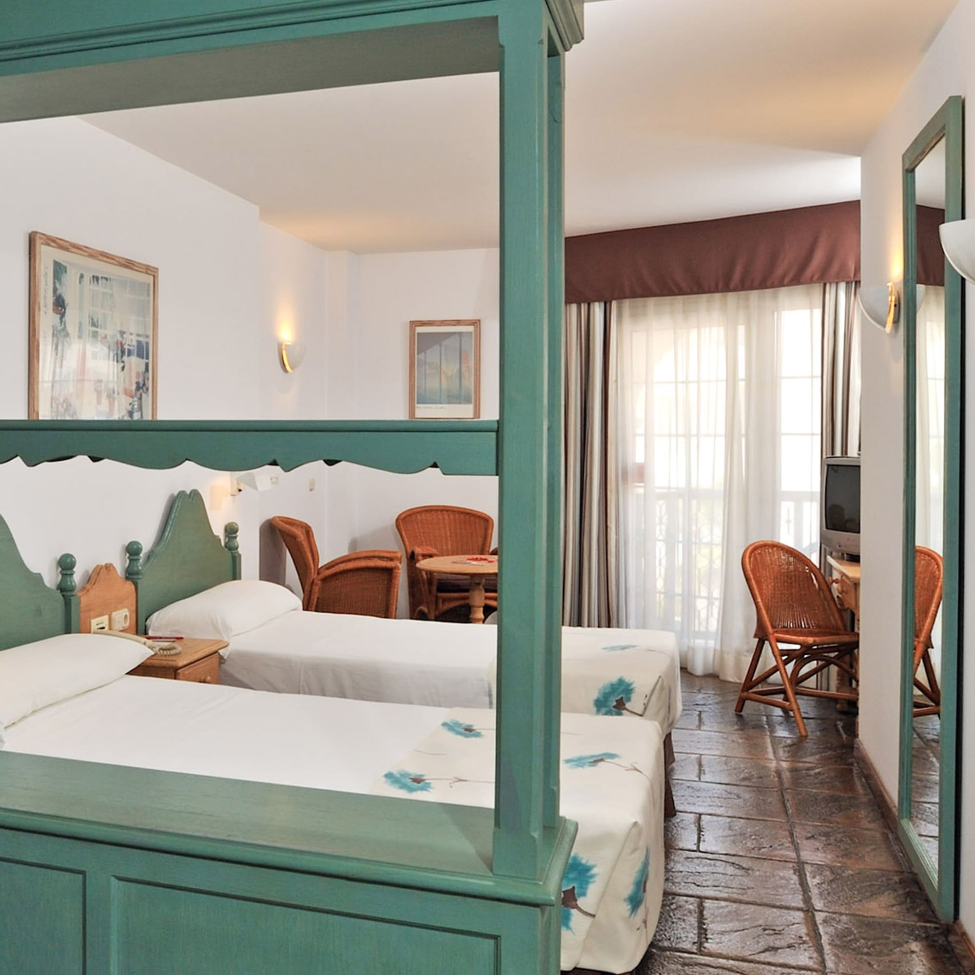 a room with two beds and a television