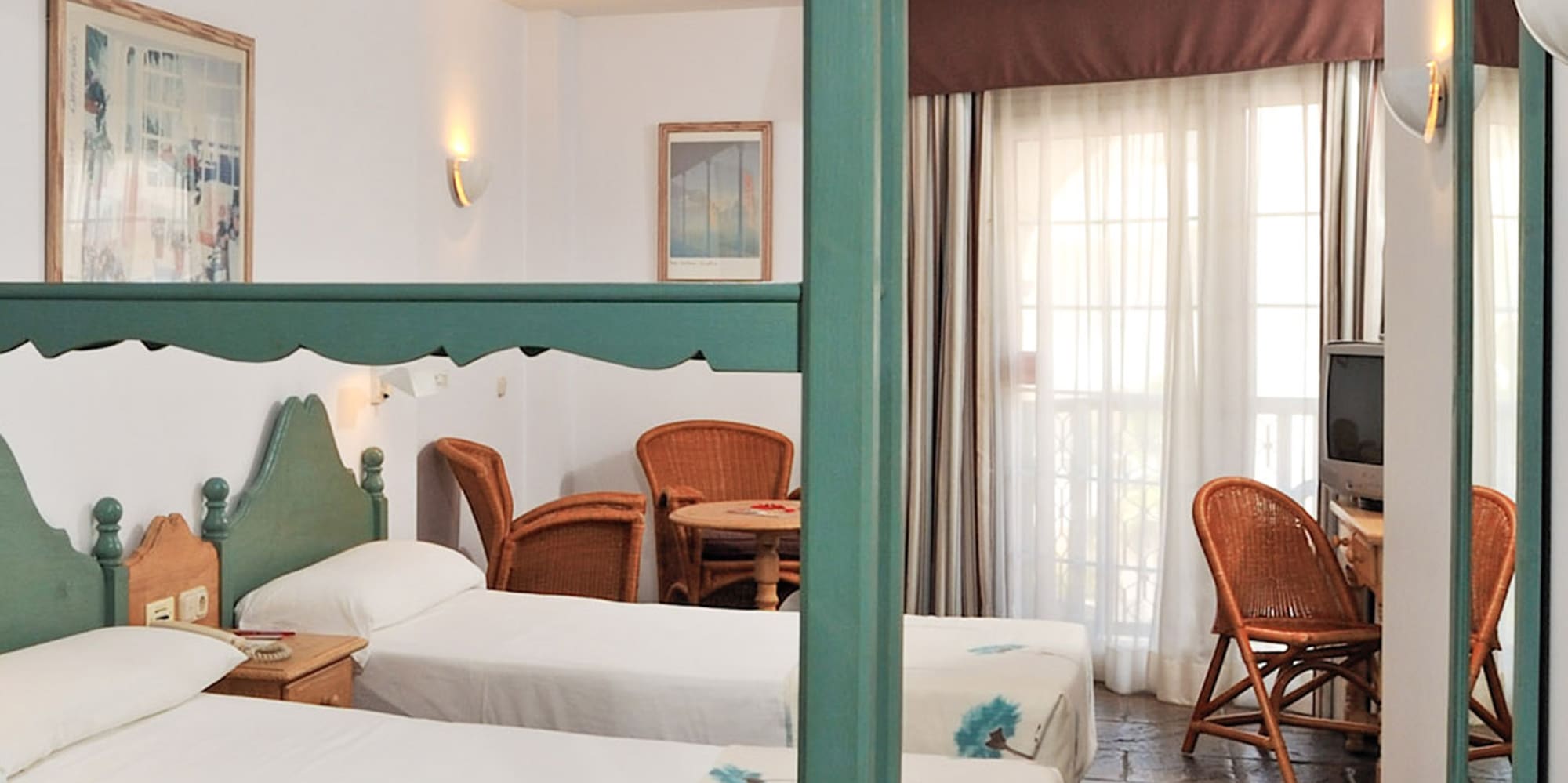 a room with two beds and a television