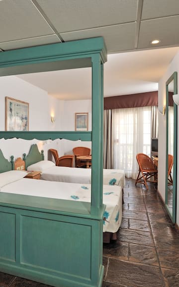 a room with two beds and a television