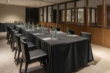 a long table with black tablecloth and chairs