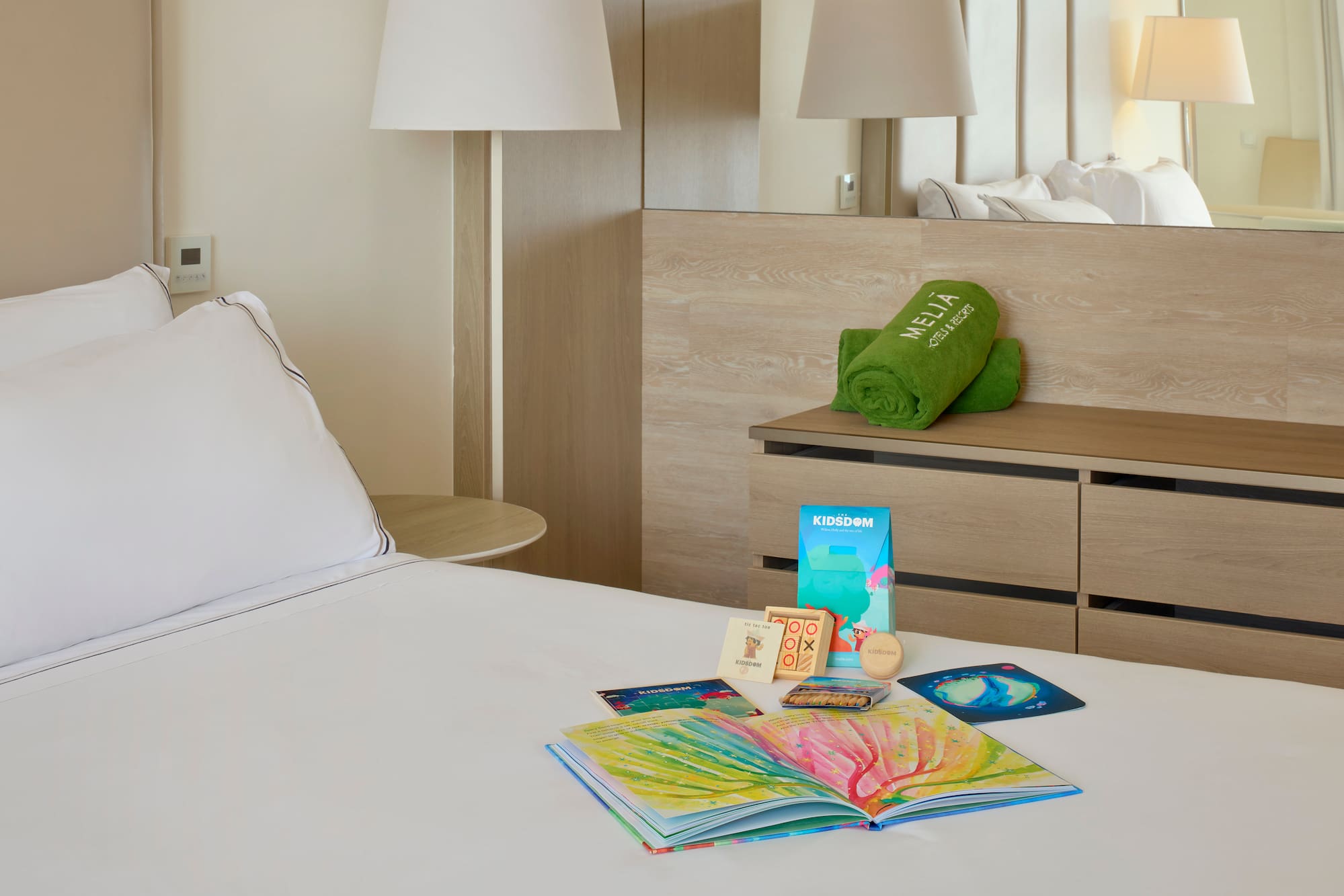 a bed with a book and a towel on it