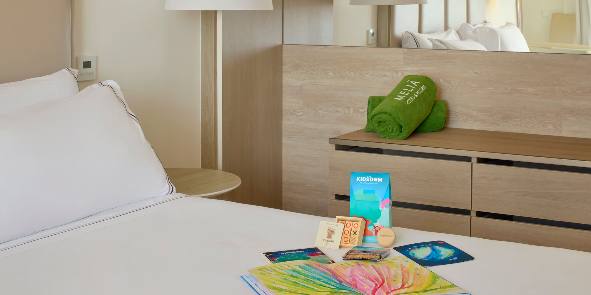 a bed with a book and a towel on it