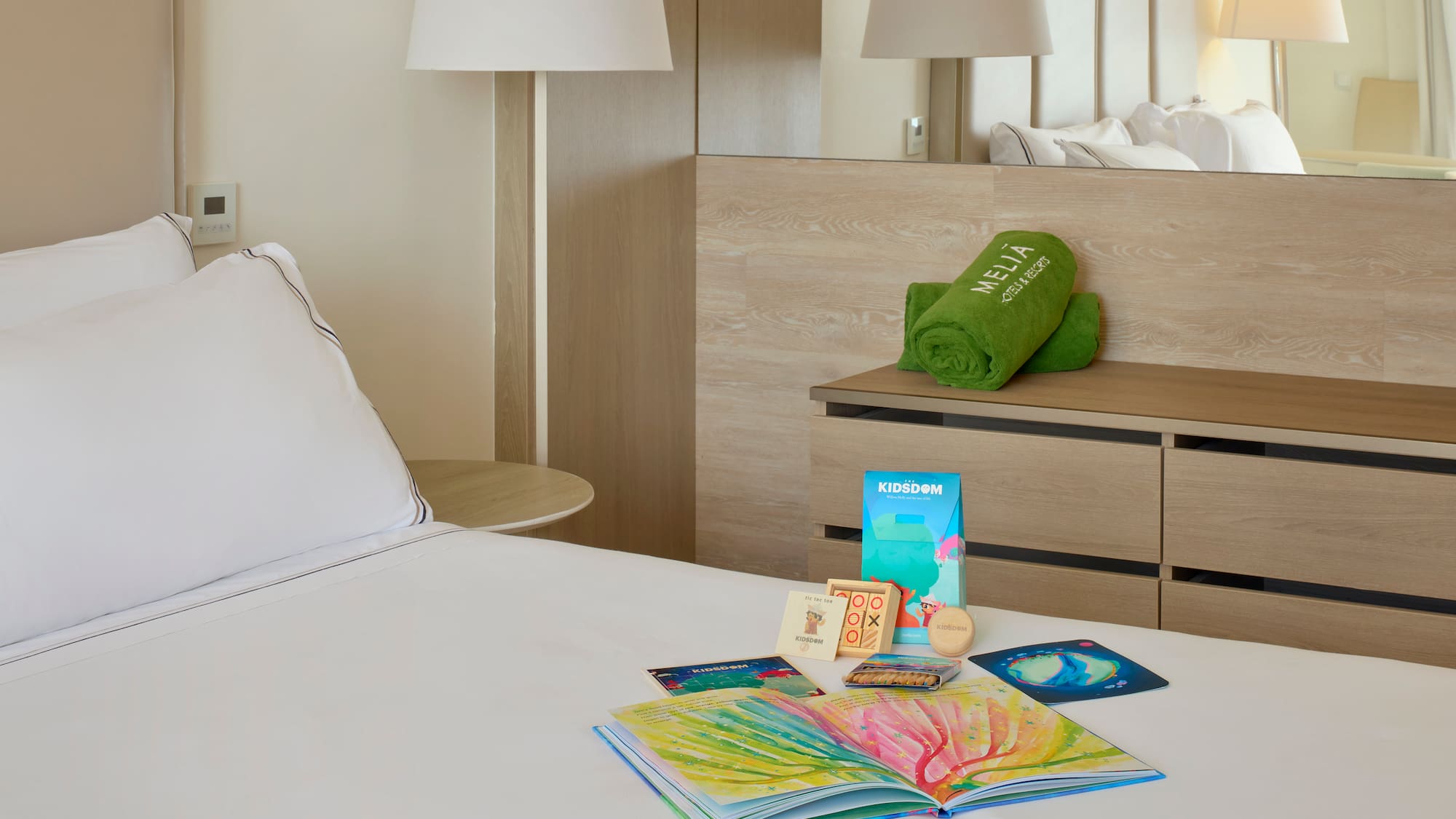 a bed with a book and a towel on it