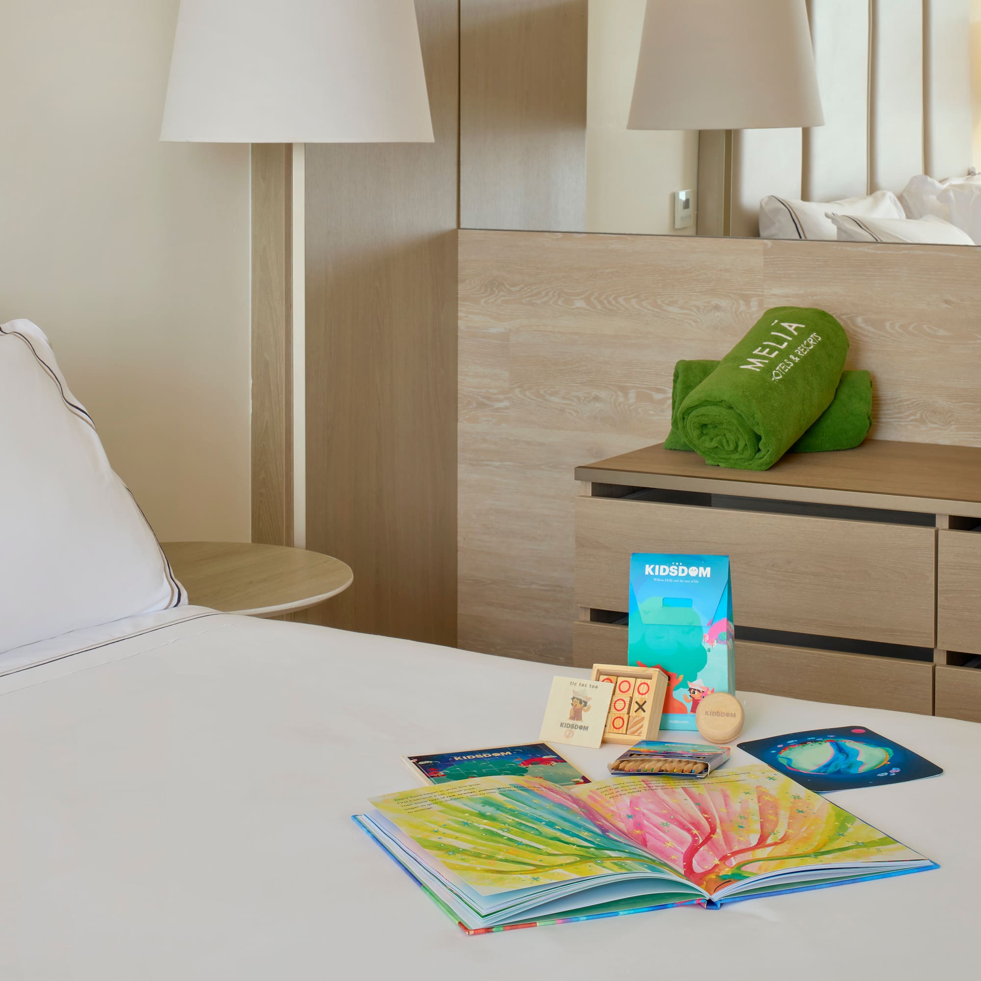 a bed with a book and a towel on it