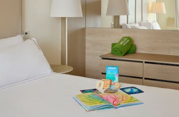 a bed with a book and a towel on it