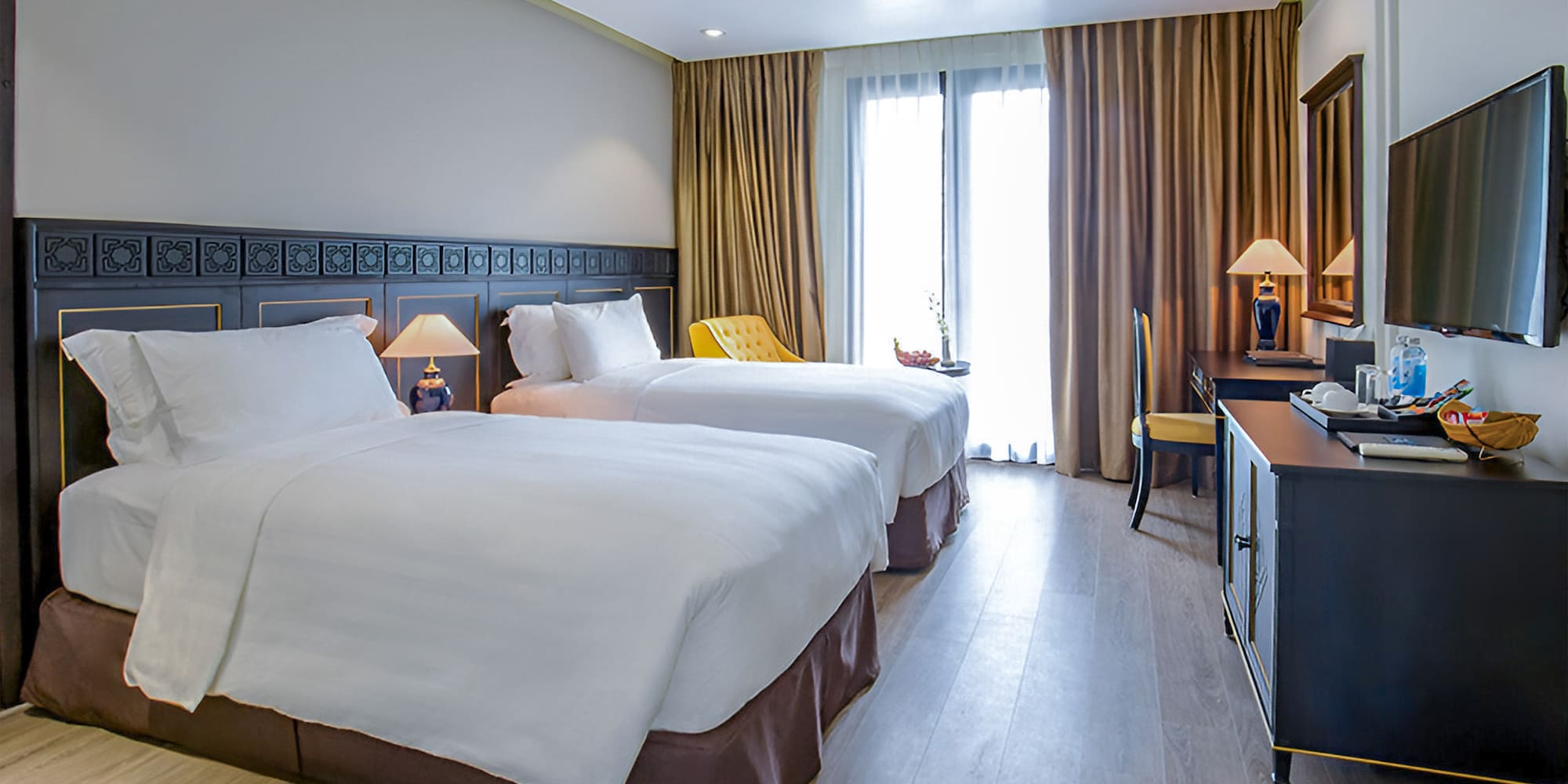 a room with two beds and a desk