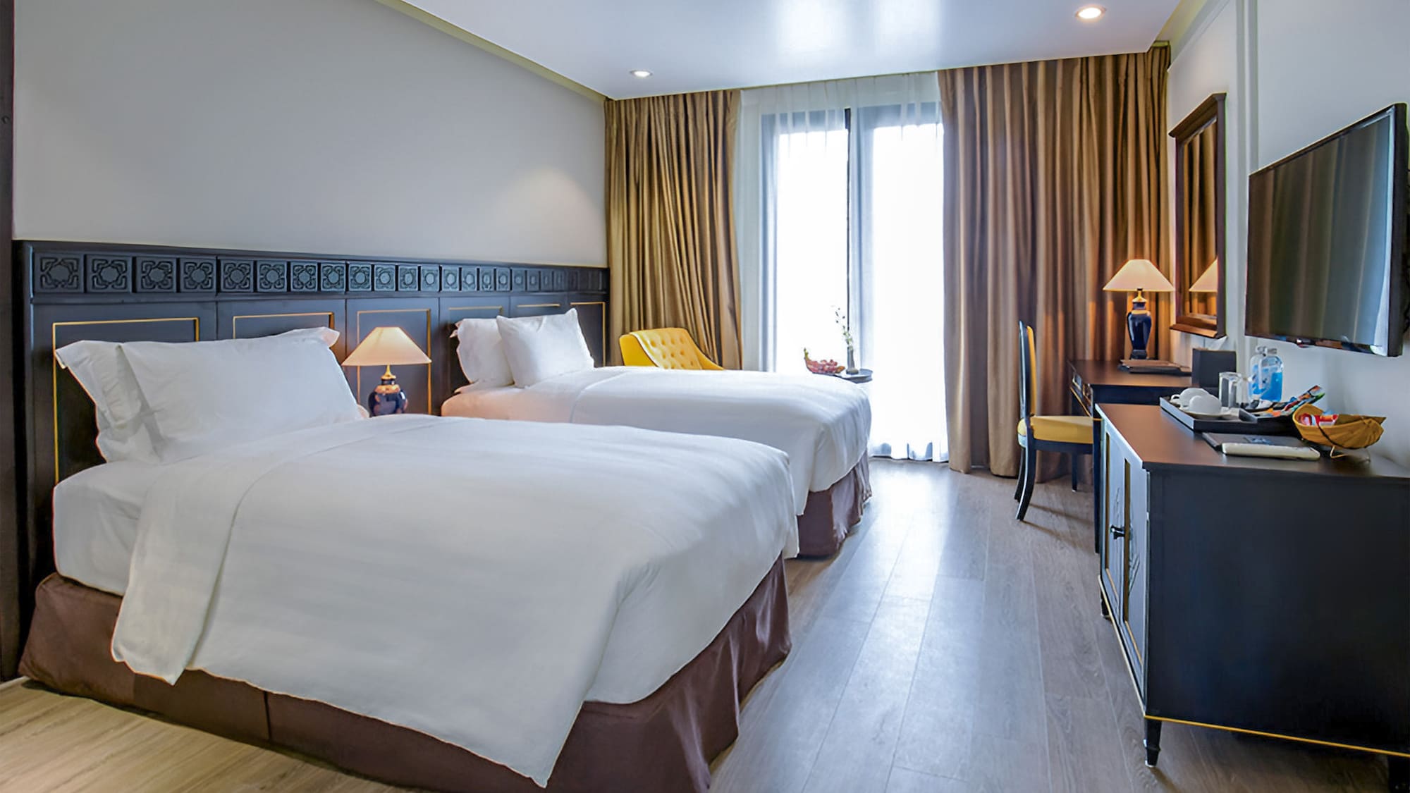 a room with two beds and a desk