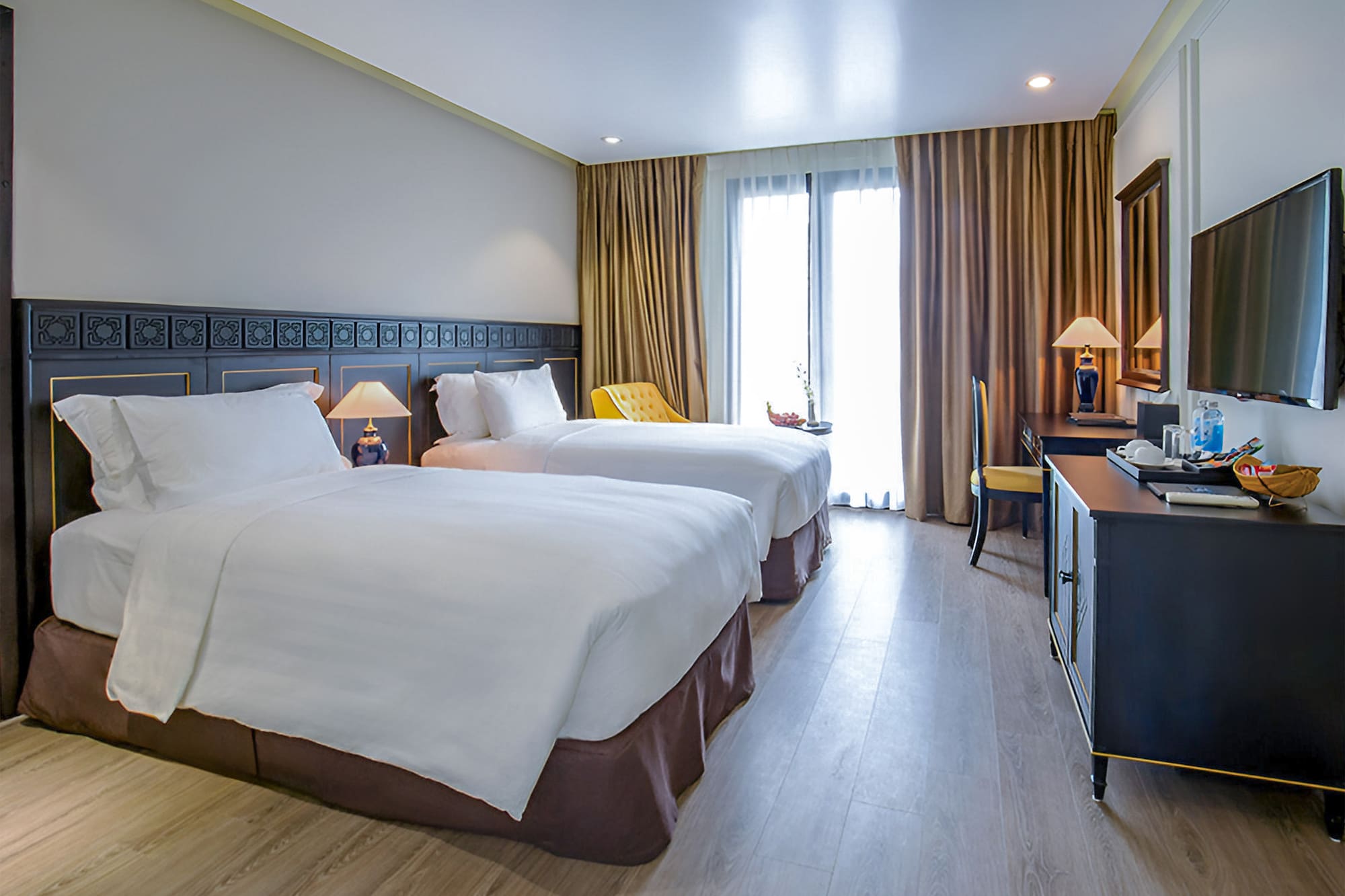 a room with two beds and a desk