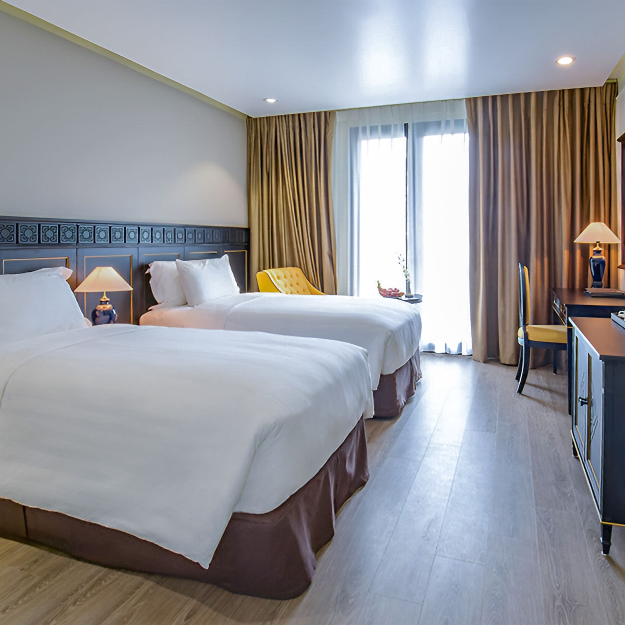 a room with two beds and a desk