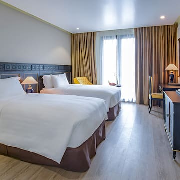 a room with two beds and a desk