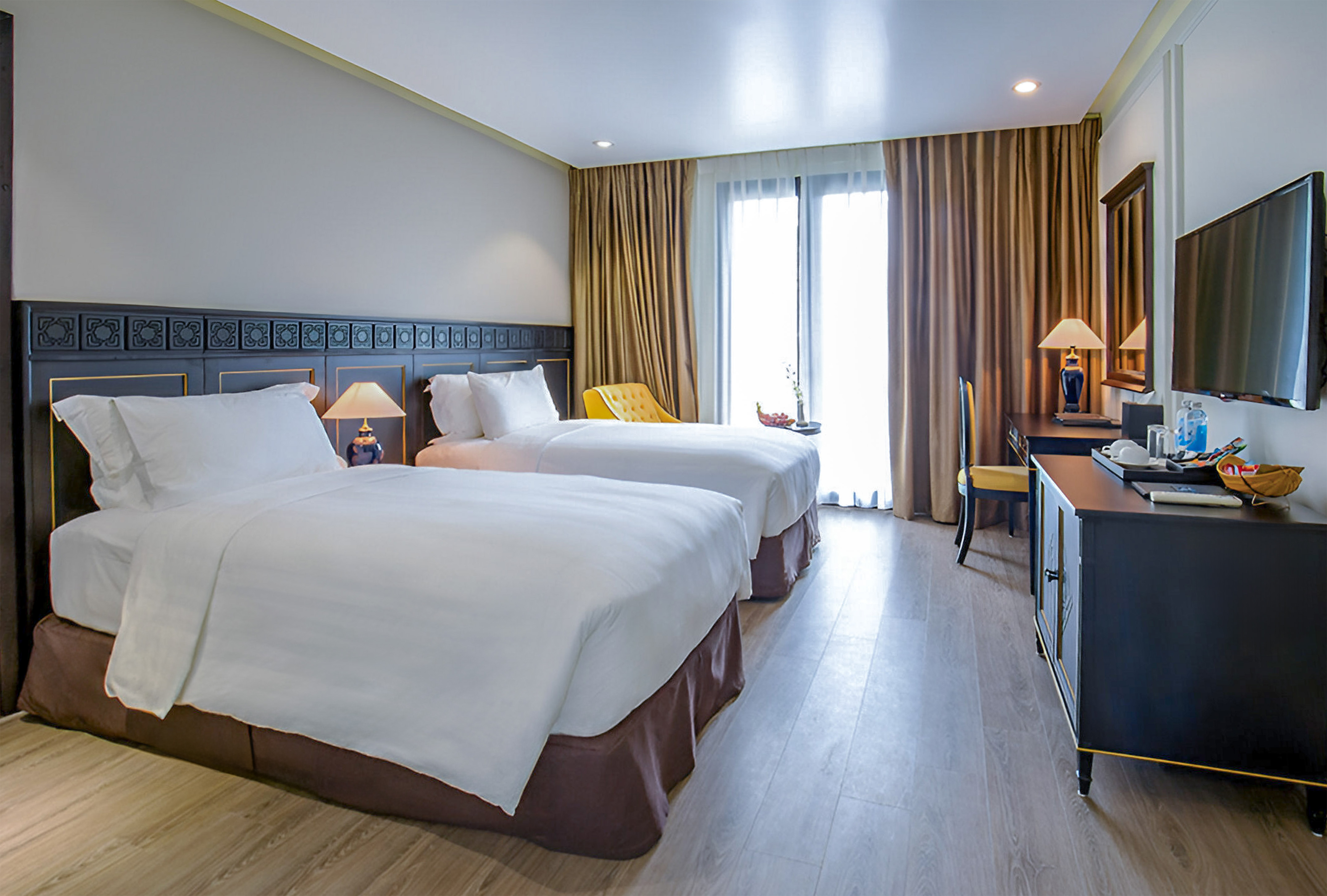 a room with two beds and a desk