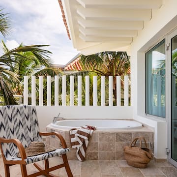 a chair and a bathtub on a patio