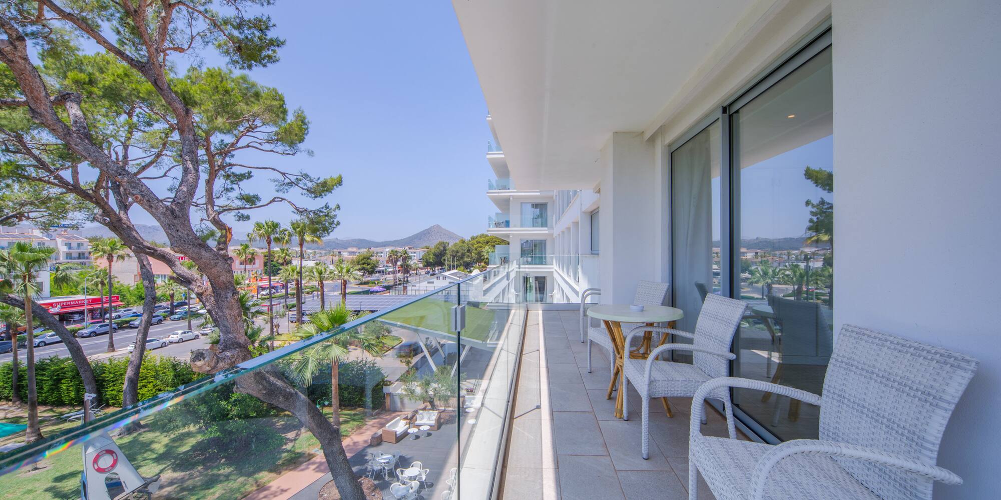 a balcony with chairs and tables