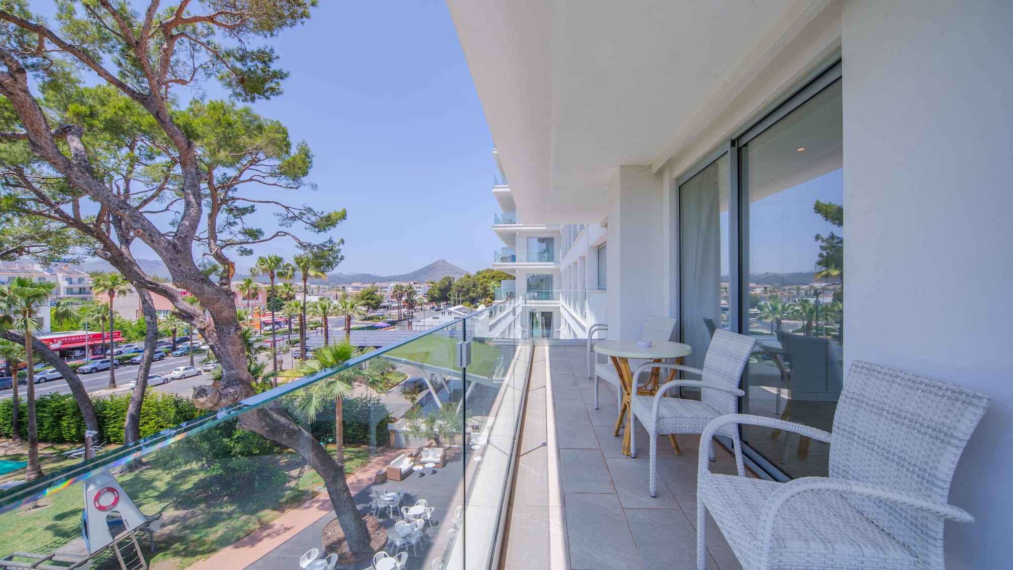a balcony with chairs and tables