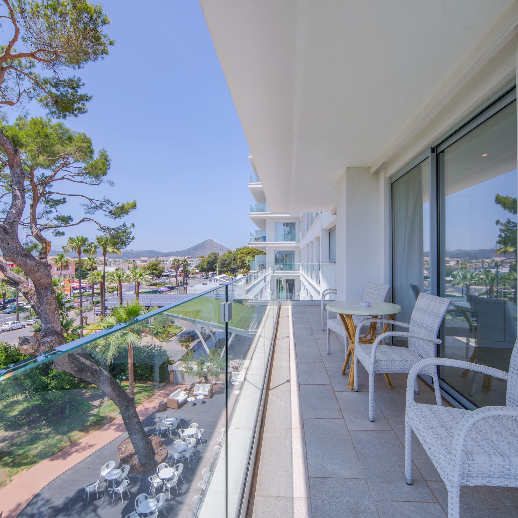 a balcony with chairs and tables