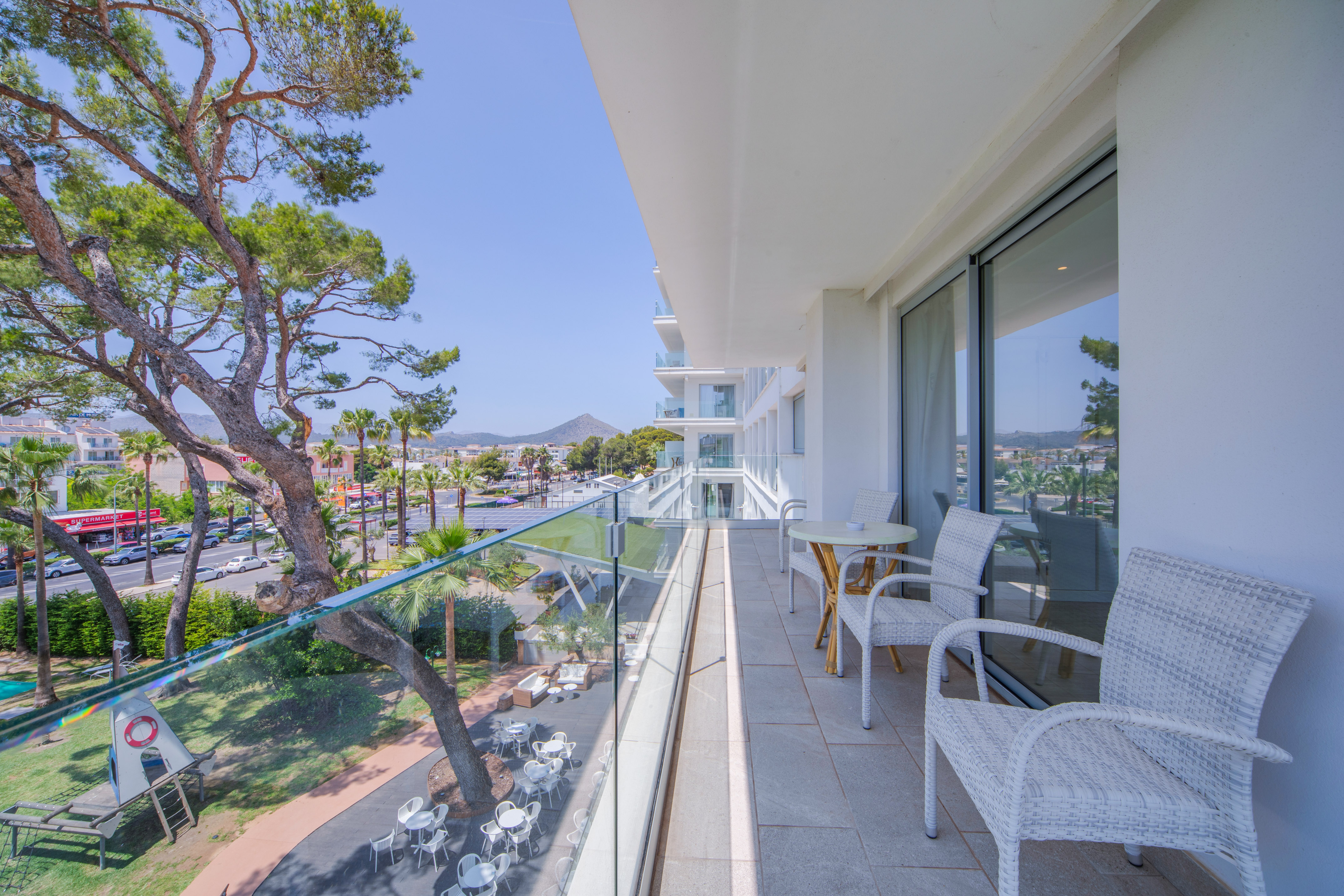 a balcony with chairs and tables