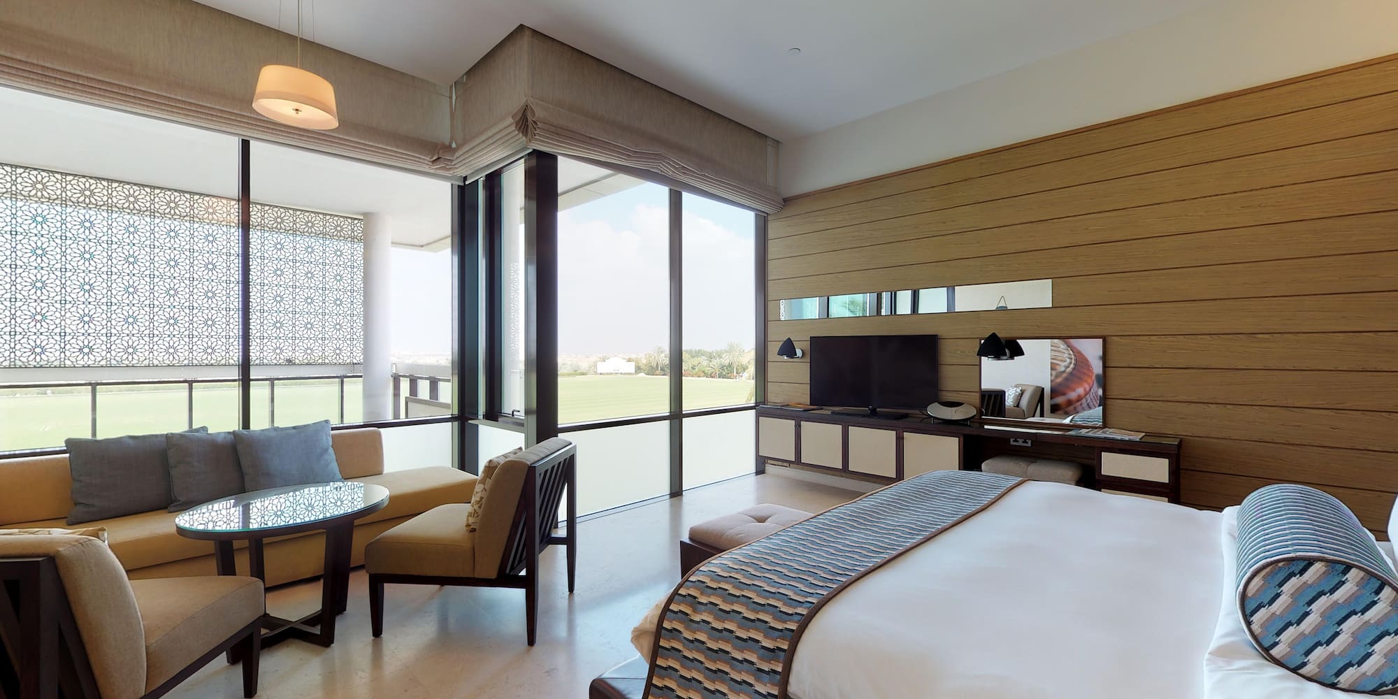 a room with a bed and a television