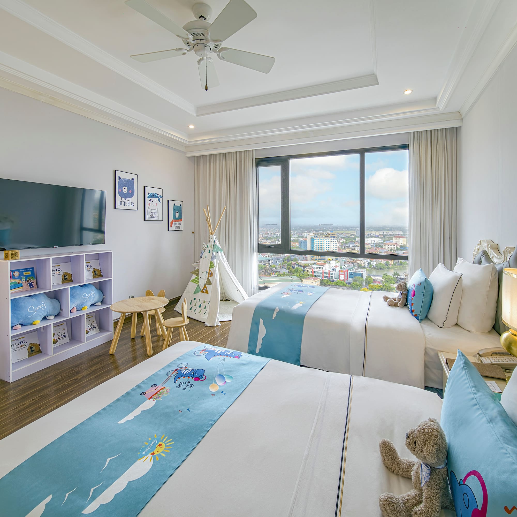 a bedroom with two beds and a window