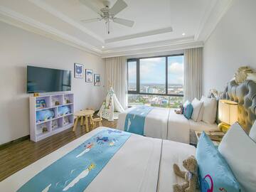 a bedroom with two beds and a window